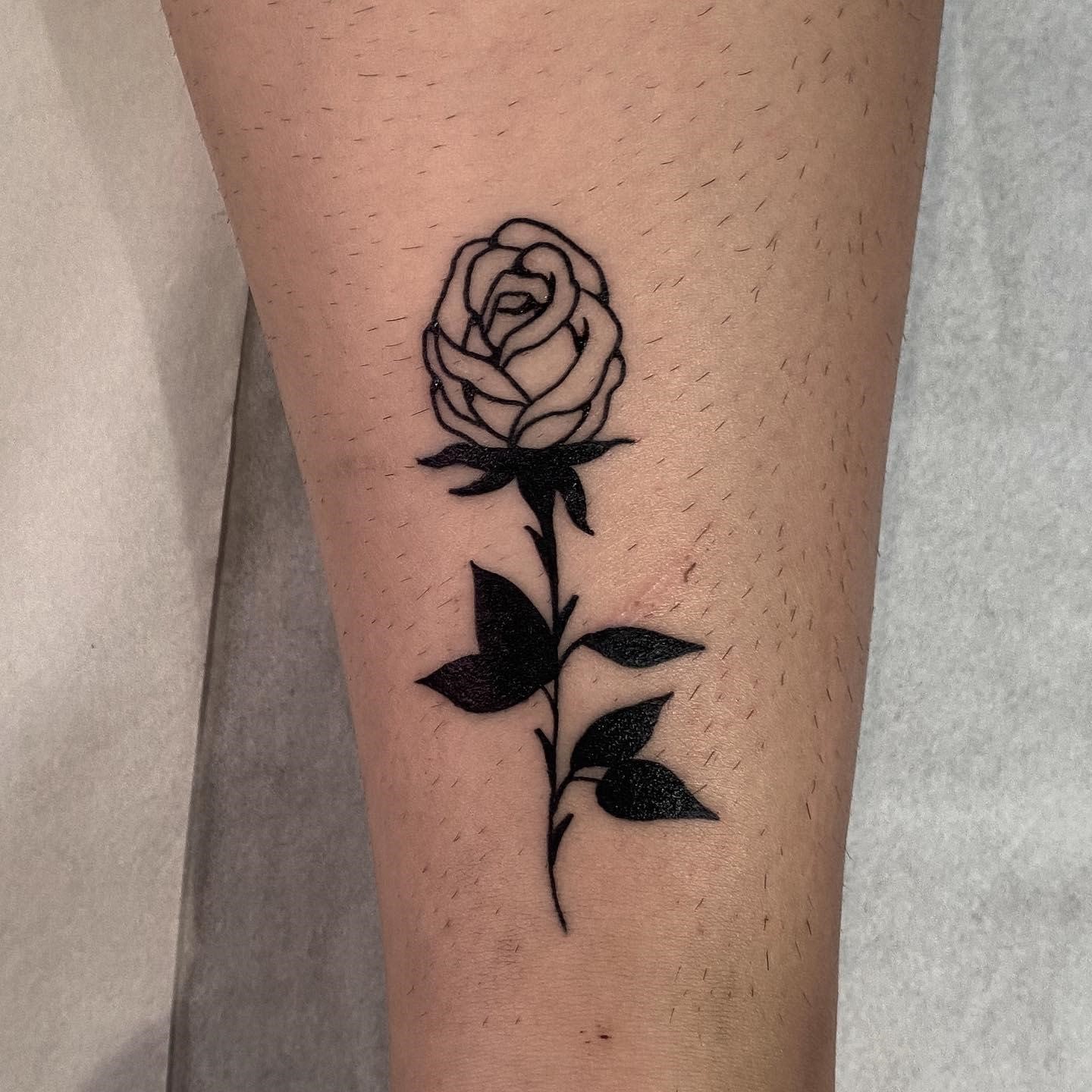 A Black And White Rose Tattoo On The Left Arm With Geometric Shapes