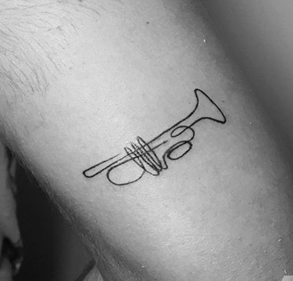 A Black And White Tattoo With A Skeleton Holding A Trumpet