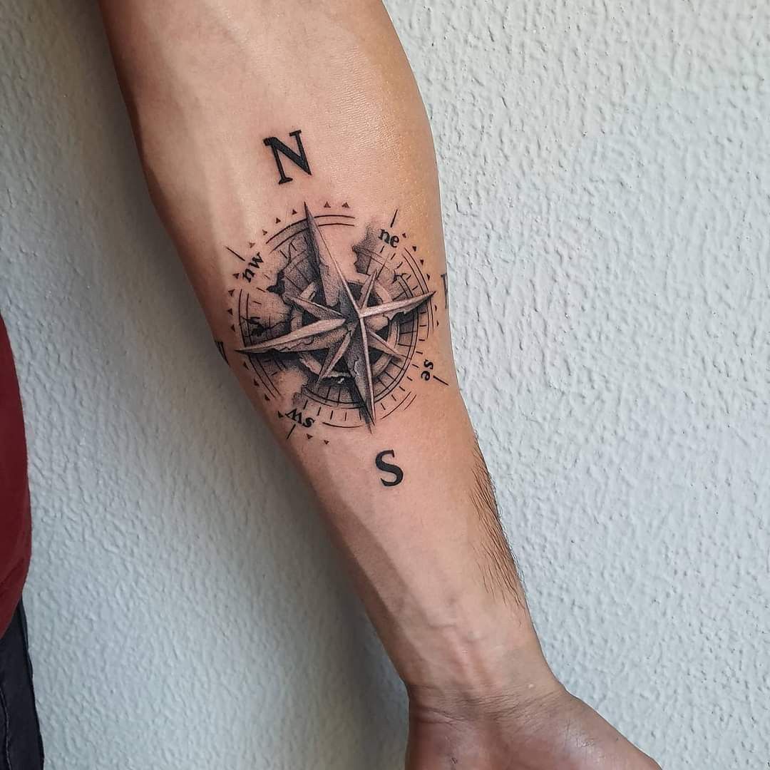 A Man S Arm With A Watercolor Compass Tattoo On The Left Side Of His Arm