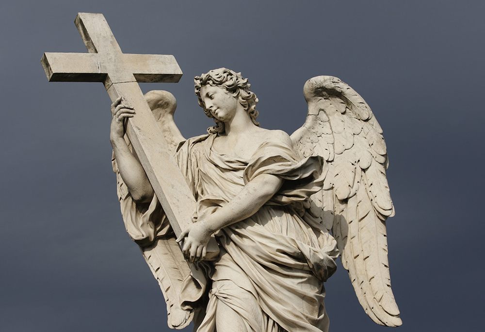 A Statue Of An Angel Carrying Christ S Cross Is Seen On The Castel Sant Angelo Bridge In Rome