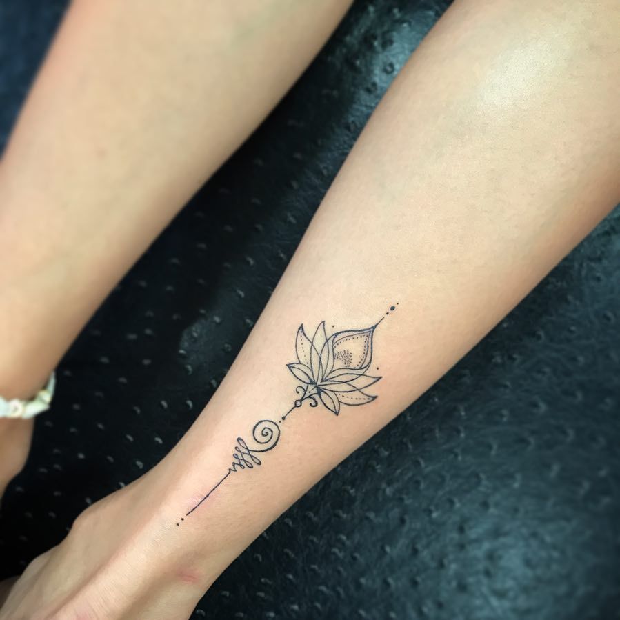 A Tattoo With A Lotus Flower On The Side Of Her Leg And An Ombrephant