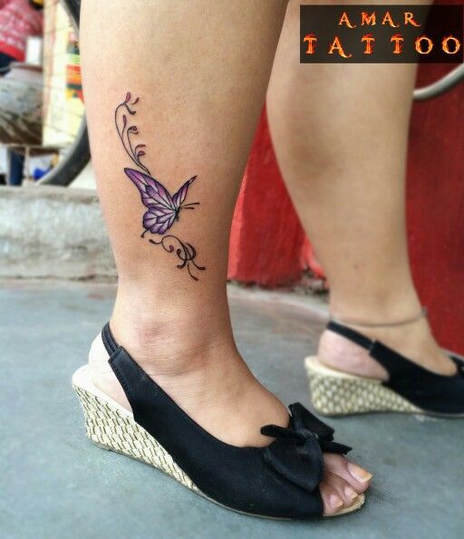 A Woman Amp 39 S Leg With A Butterfly Tattoo On The Side Of Her Leg