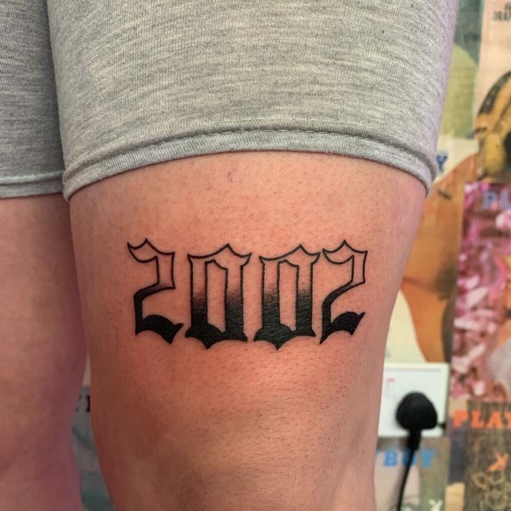 Birth Year Tattoo: Perfect Placement Above Knee