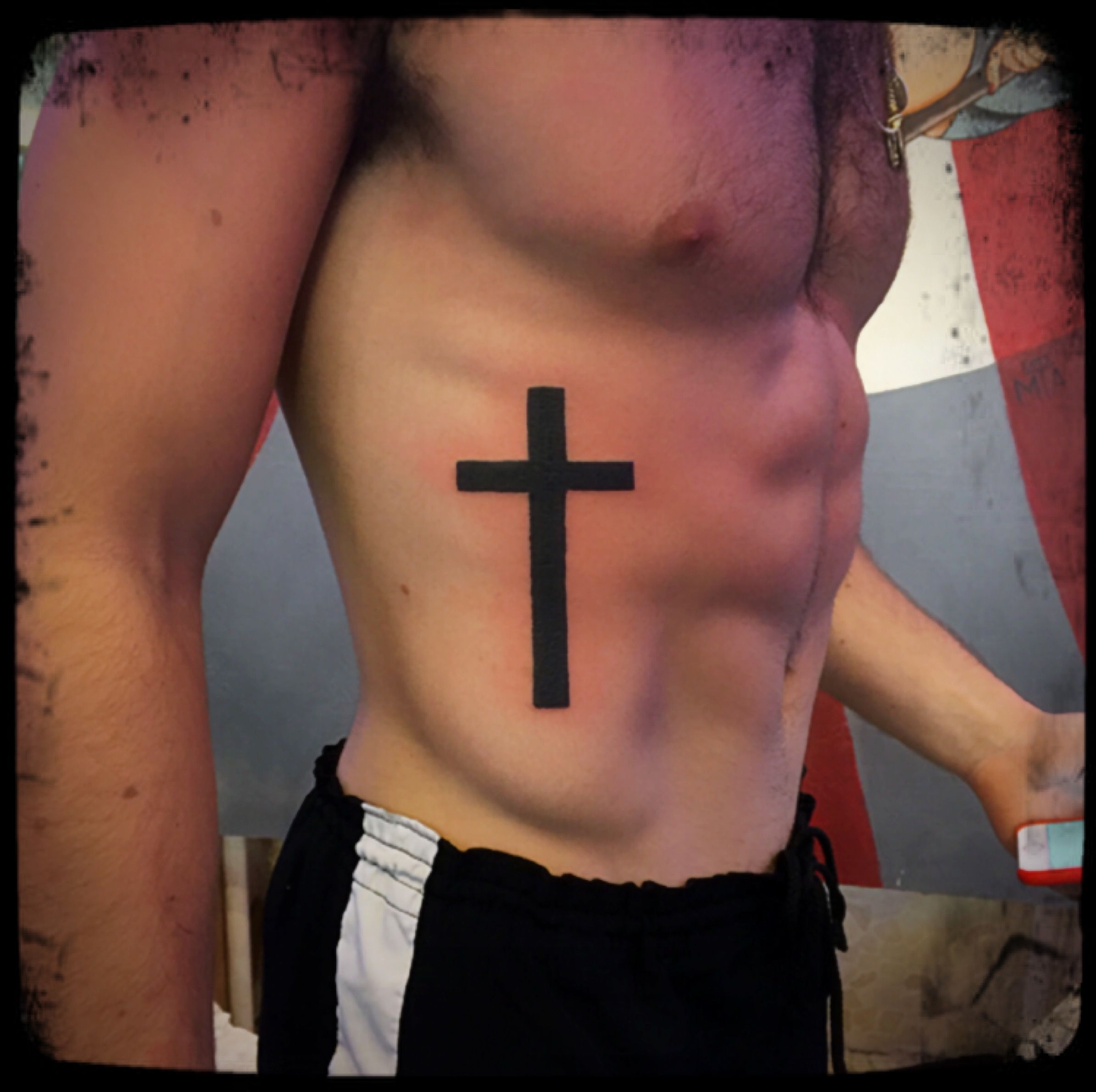 Cross Tattoo on Ribs: Meaning and Design Ideas