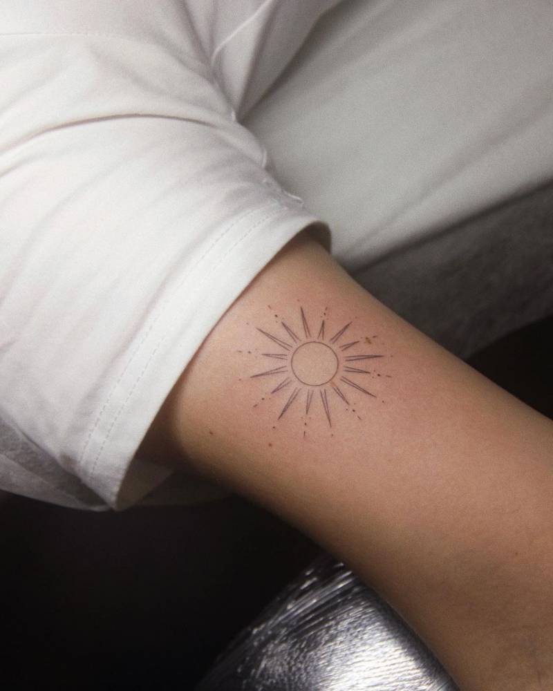 Fine Line Sun Tattoo On The Bicep