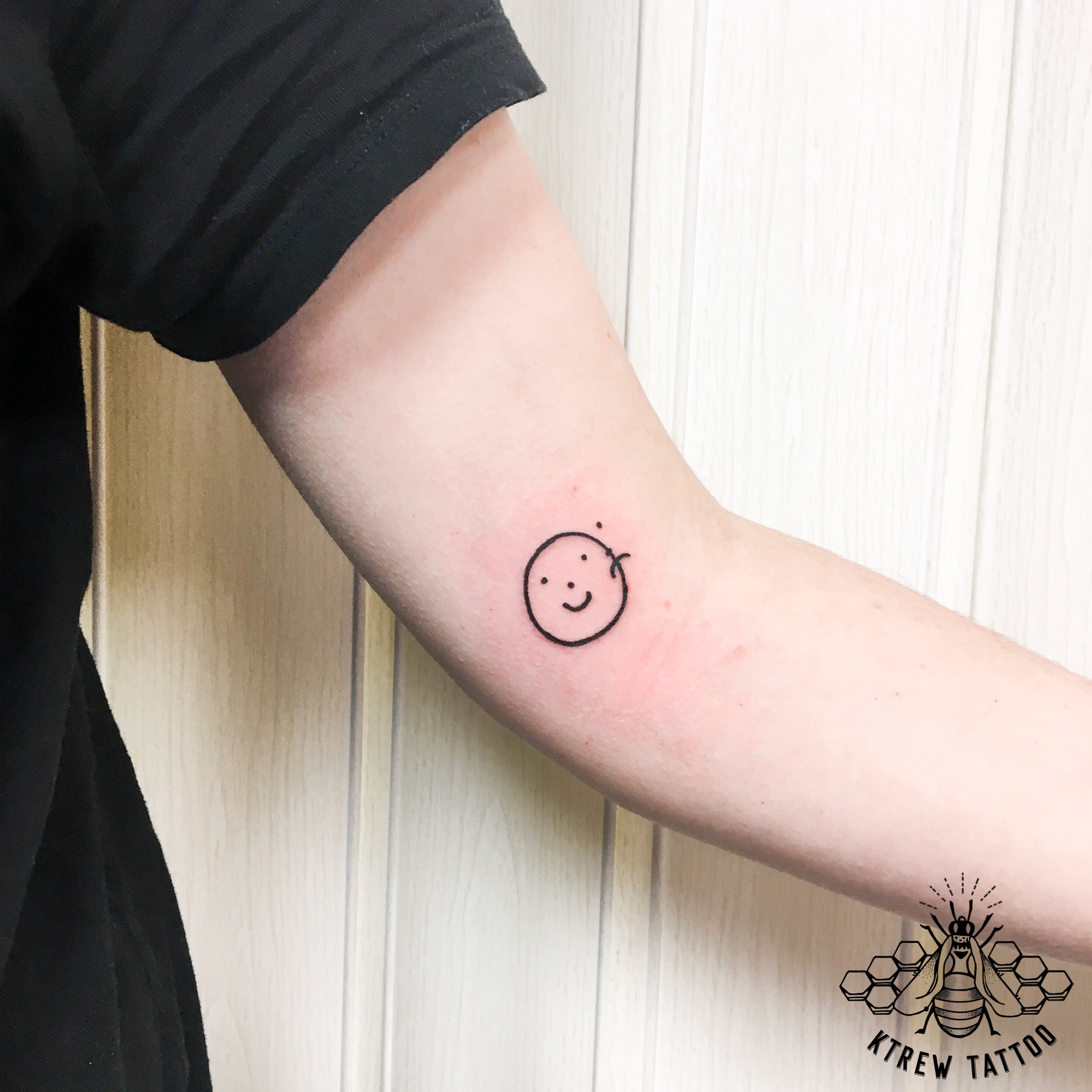 Happy Sad Face Tattoo Located On The Inner Forearm