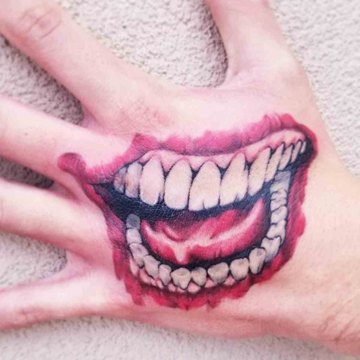 5 Stunning Joker Smile Hand Tattoo Designs