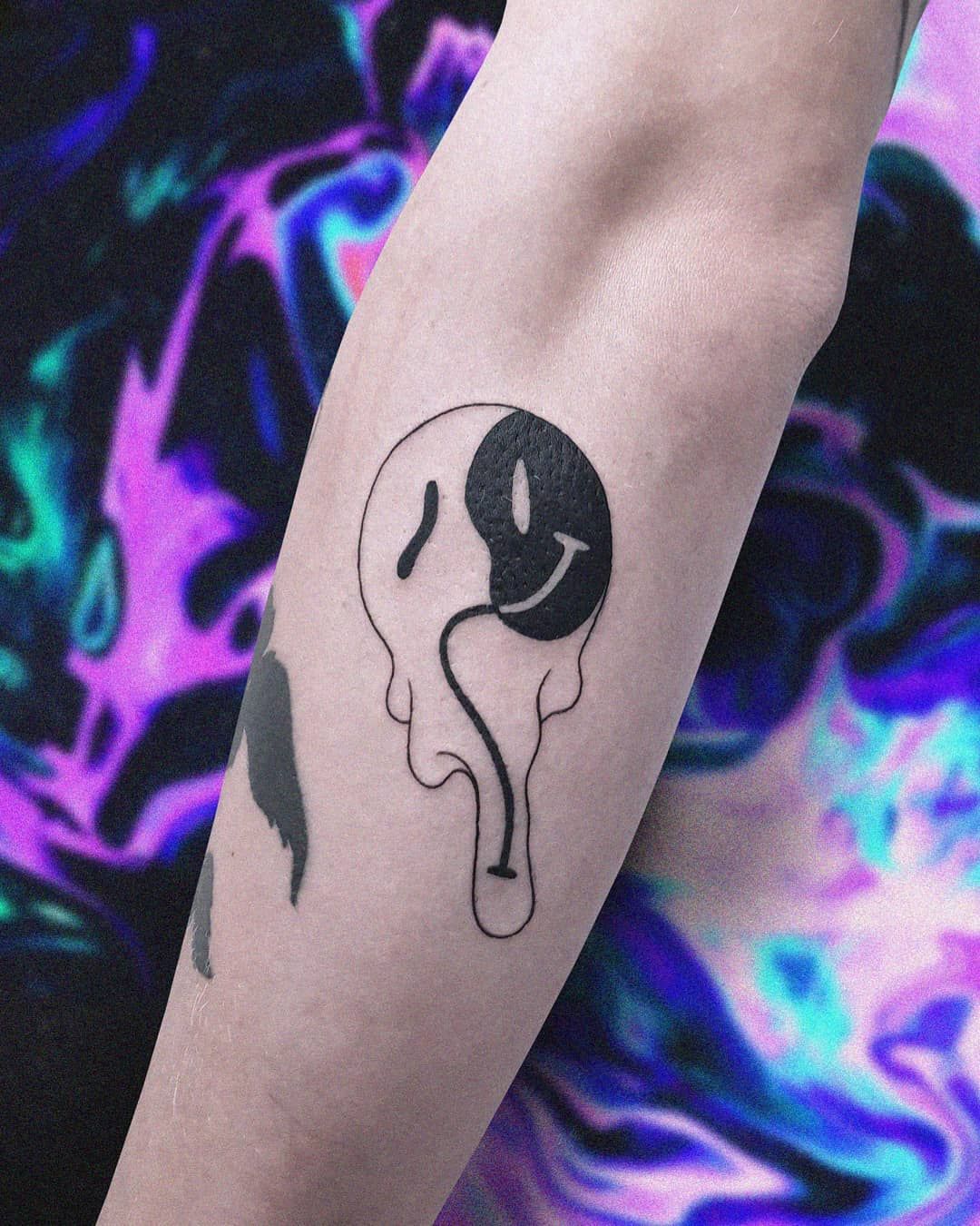 Discover the Trendy Melting Smiley Face Tattoo Design