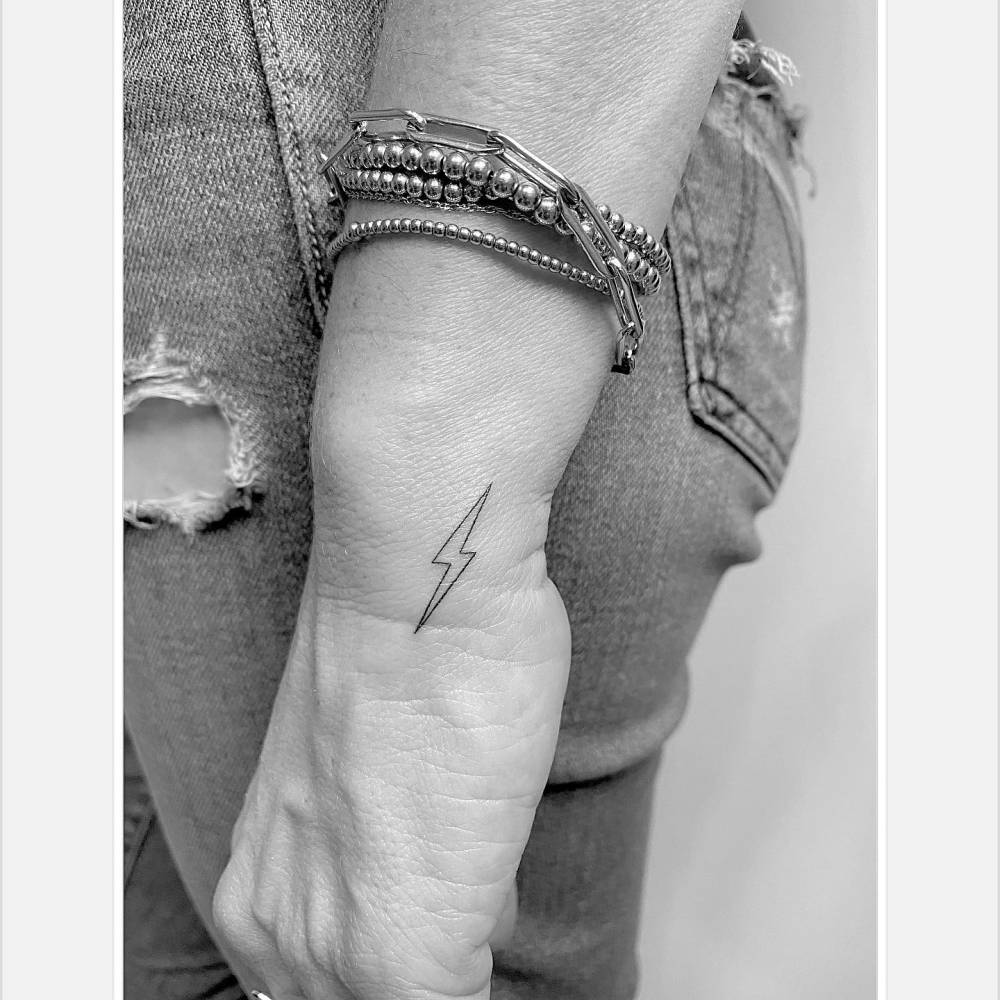 Minimalistic Style Lightning Bolt Tattoo Located On The