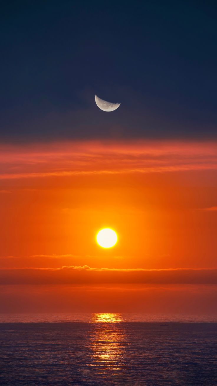 Moon Sinking Into The Ocean