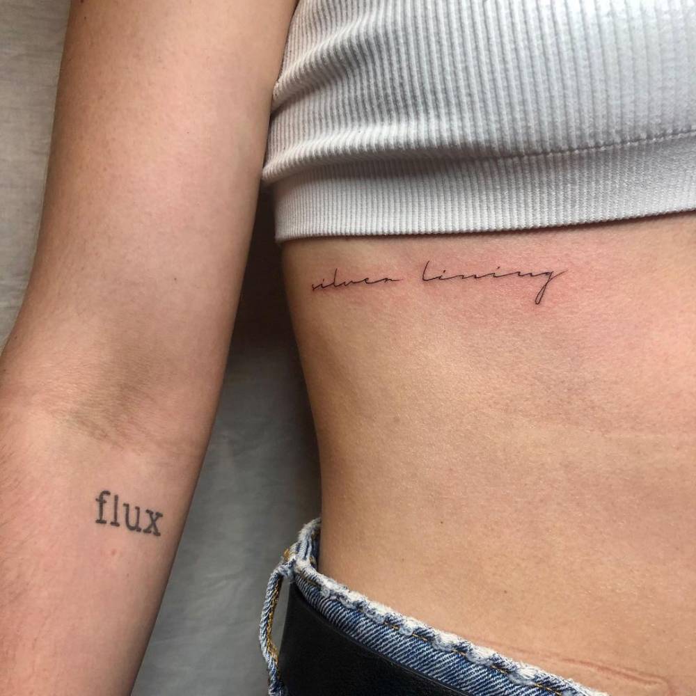 Tattoo Written Silver Lining Pleaced On The Rib